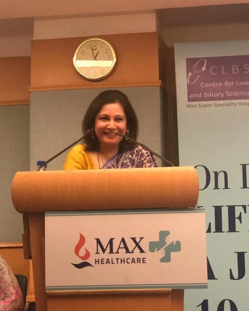 Shefali Chopra speaking at a podium at Max Healthcare